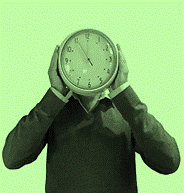 A person holding a clock in front of their face on a green background